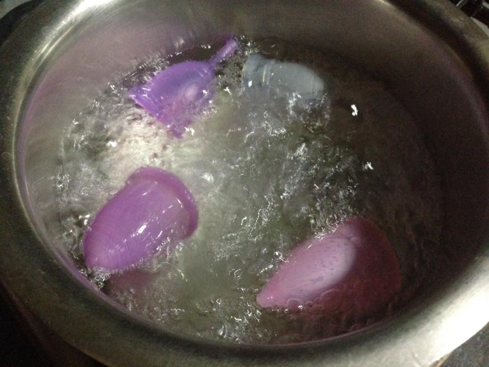 A menstrual cup being boiled in a pot of water. Importance of cleaning a menstrual cup before and after use to avoid infection. Regular or drinking water can be used to wash the cup after removal and re-insertion. Mild and unscented soap can be used once a day for cleaning. Avoid using products with oil or Dettol."