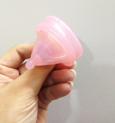 A collection of menstrual cups of various sizes and shapes, highlighting the discomfort associated with a one-size-fits-all approach. Choosing the right menstrual cup size and body type is important for a comfortable and effective fit.